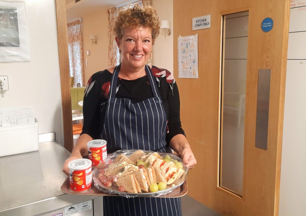 Care home catering staff preparing a meal